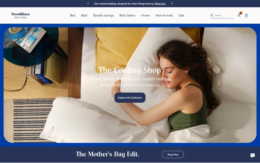 Brooklinen homepage screenshot — Cooling Shop hero, model on linen bedding, Bundle Savings and Best Sellers nav.